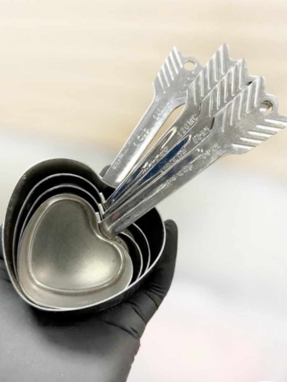Beehive Handmade stainless steel nesting heart-and-arrow measuring cups.